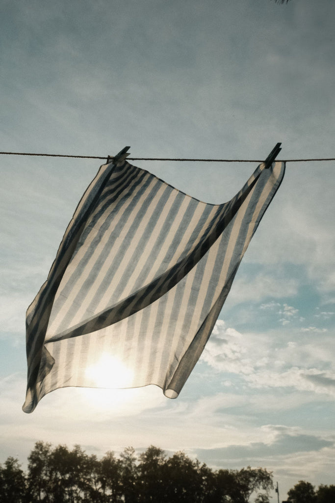 Indigo blue and white vertical striped cotton bandana by World of Crow, handwoven in India using natural dyes and traditional weaving techniques – sustainable unisex accessory for everyday wear.