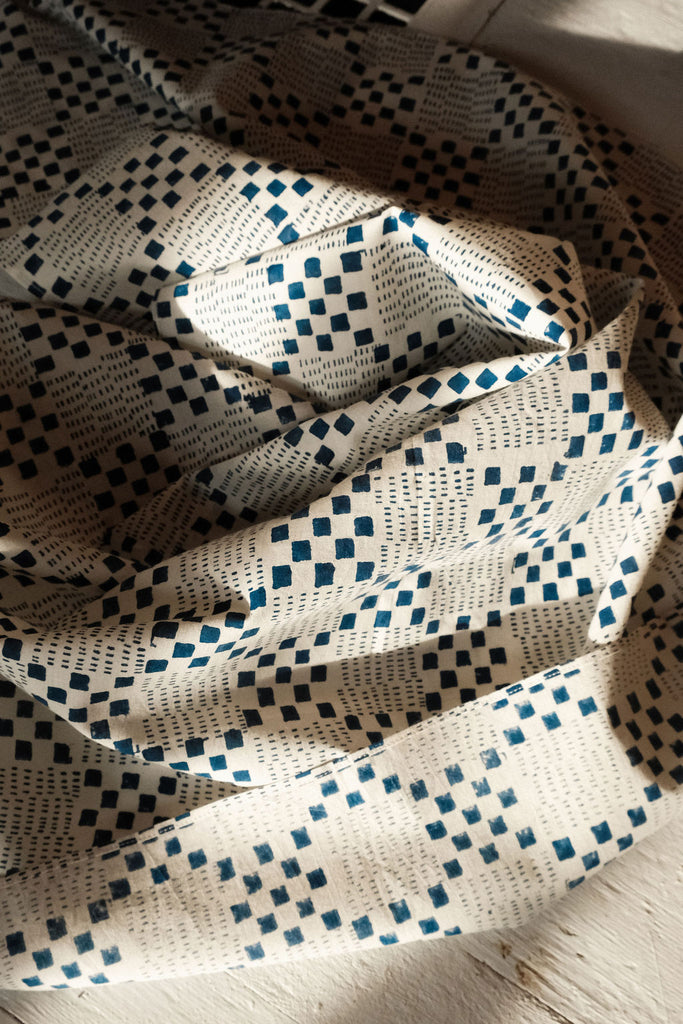 Navy blue and white handwoven checkered cotton bandana by World of Crow, ethically made in India using traditional weaving techniques – sustainable slow fashion accessory for versatile styling.