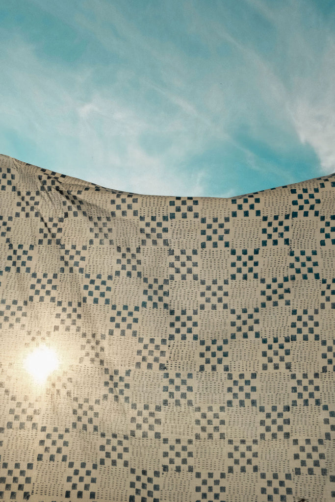 Navy blue and white handwoven checkered cotton bandana by World of Crow, ethically made in India using traditional weaving techniques – sustainable slow fashion accessory for versatile styling.