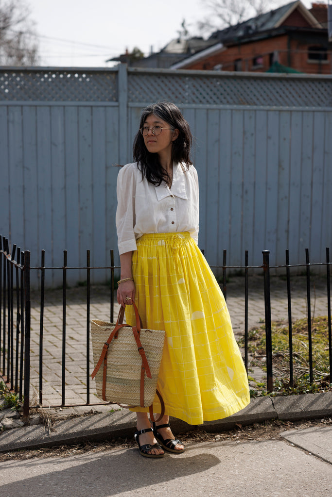 This Lemon Sorbet Skirt is made in collaboration between Erica Kim @ahistoryofarchitecture and World of Crow, it has a yellow color, checks detailing, jamdani fabric, ankle length skirt