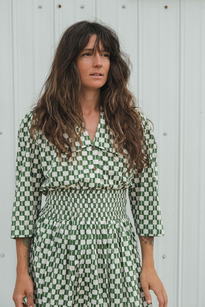 Green and white hand block-printed skirt made from 100% organic cotton, featuring a soft, lightweight fabric with azo-free dyes. Designed with a comfortable elasticated waist, full lining, and side pockets, this ethically made skirt falls 36” from the waist and fits true to size with a relaxed drape over the hips and legs. Each piece is uniquely handcrafted, with natural variations in color and pattern that reflect its artisanal charm—ideal for effortless, everyday wear.