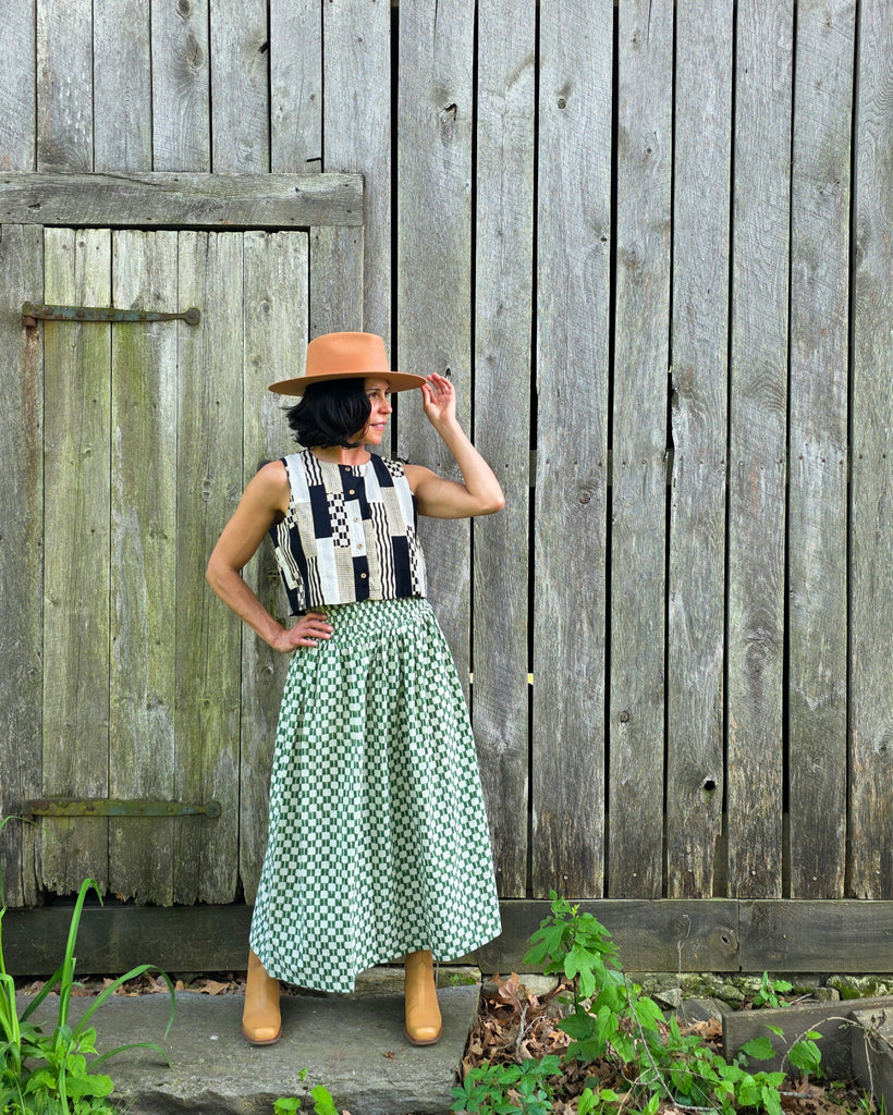 Green and white hand block-printed skirt made from 100% organic cotton, featuring a soft, lightweight fabric with azo-free dyes. Designed with a comfortable elasticated waist, full lining, and side pockets, this ethically made skirt falls 36” from the waist and fits true to size with a relaxed drape over the hips and legs. Each piece is uniquely handcrafted, with natural variations in color and pattern that reflect its artisanal charm—ideal for effortless, everyday wear.