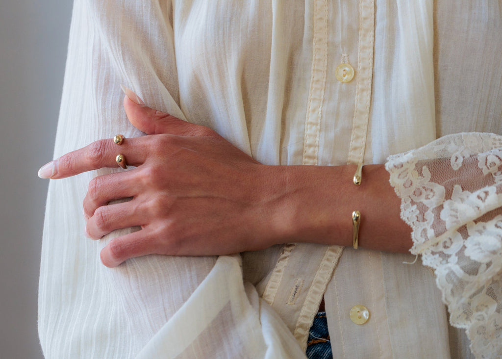 Introducing the Sustainable Gold Cuff Bracelet, cast from seapods found along North Fork shores. Available in Small (5 1/2”) and Medium/Large (6”) sizes, this flexible piece supports marine research. Combining eco-conscious craftsmanship with a commitment to environmental preservation, it offers a unique, timeless addition to any collection.