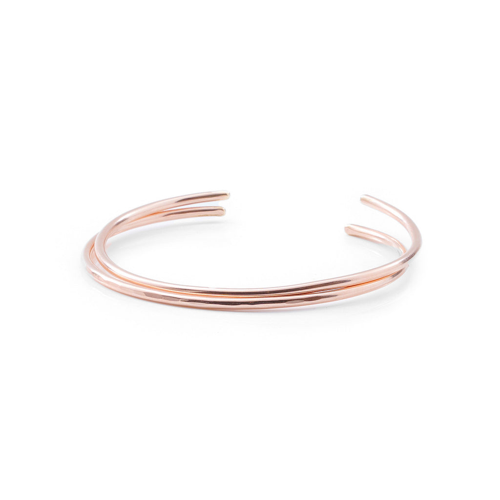 Introducing a beautifully crafted rose gold cuff bracelet, designed with two delicate wires. Available in both smooth and hammered finishes, this elegant piece is offered in sizes ranging from X-Small to Large, with custom sizing options to ensure a perfect fit.