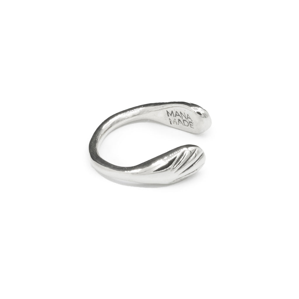 Introducing the sustainably hand-casted silver ring from the Mana Made x CCE Collection, featuring a distinctive wave design inspired by the sea. Crafted from recycled sterling silver and brass, this adjustable ring fits sizes 6 to 9, embodying a commitment to both style and environmental responsibility.