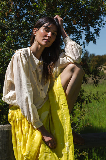Introducing the Vintage Bertha Blouse, a timeless summer staple exuding effortless charm. Crafted from handwoven cotton in a serene off-white hue, it offers versatility and breathability for warmer days. Boasting a classic bertha collar, three-quarter sleeves, and a straight hem, this blouse epitomizes understated elegance. Pair it with any bottom for a stylish ensemble suitable for any occasion.