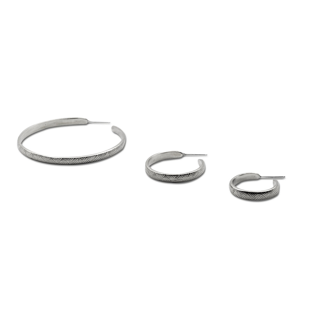 Introducing our vintage-inspired sterling silver hoop earrings, elegantly designed with a graceful curve. Available in small, medium, and large sizes, these hoops offer timeless sophistication and versatility. Handcrafted in solid sterling silver, they are a perfect choice for adding a touch of refined style to any outfit.