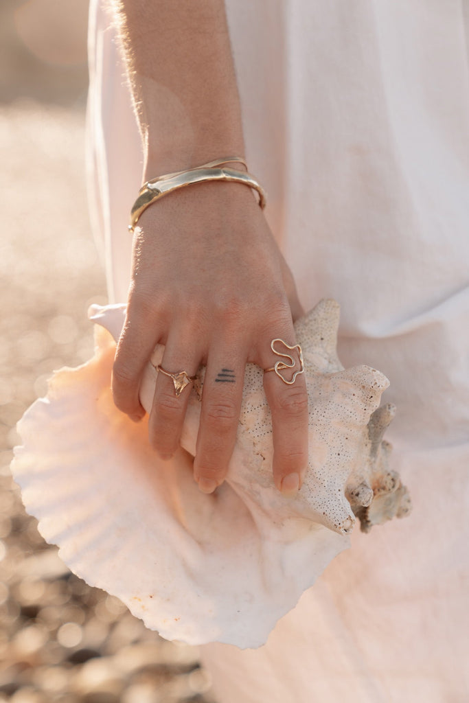 Introducing our handcrafted gold bangles, meticulously made in Downtown Los Angeles. Each bangle features a unique tactile texture and luxurious melted drips, creating an elegant and distinctive look. Perfectly combining craftsmanship with a touch of sophistication, these bangles are designed to elevate any ensemble.