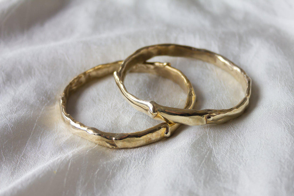 Introducing our handcrafted gold bangles, meticulously made in Downtown Los Angeles. Each bangle features a unique tactile texture and luxurious melted drips, creating an elegant and distinctive look. Perfectly combining craftsmanship with a touch of sophistication, these bangles are designed to elevate any ensemble.