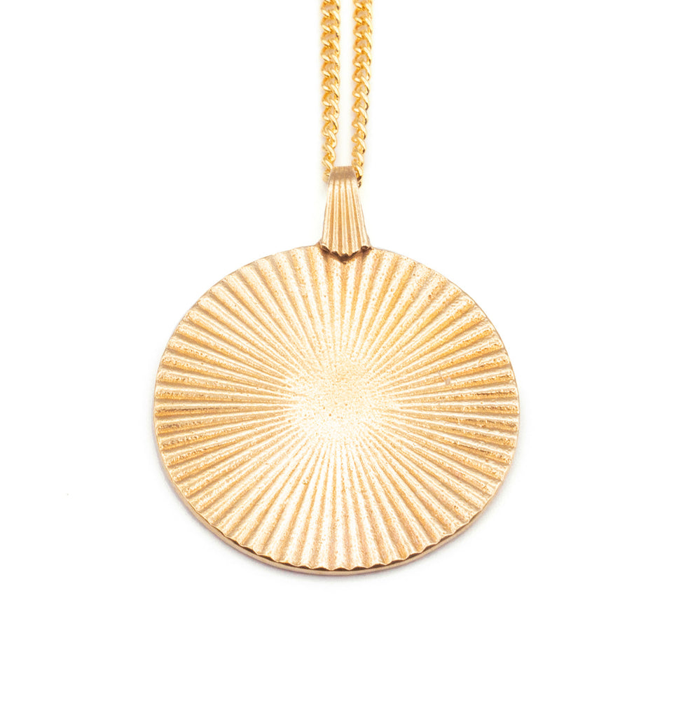 Introducing the Vintage-Inspired Gold Sunburst Pendant Necklace. This elegant gold disc features a sunburst design, gracefully suspended from a 21" chain. Choose between a 14K Gold Plated Curb Chain or a 14K Gold Filled Link Chain for a touch of customizable sophistication.